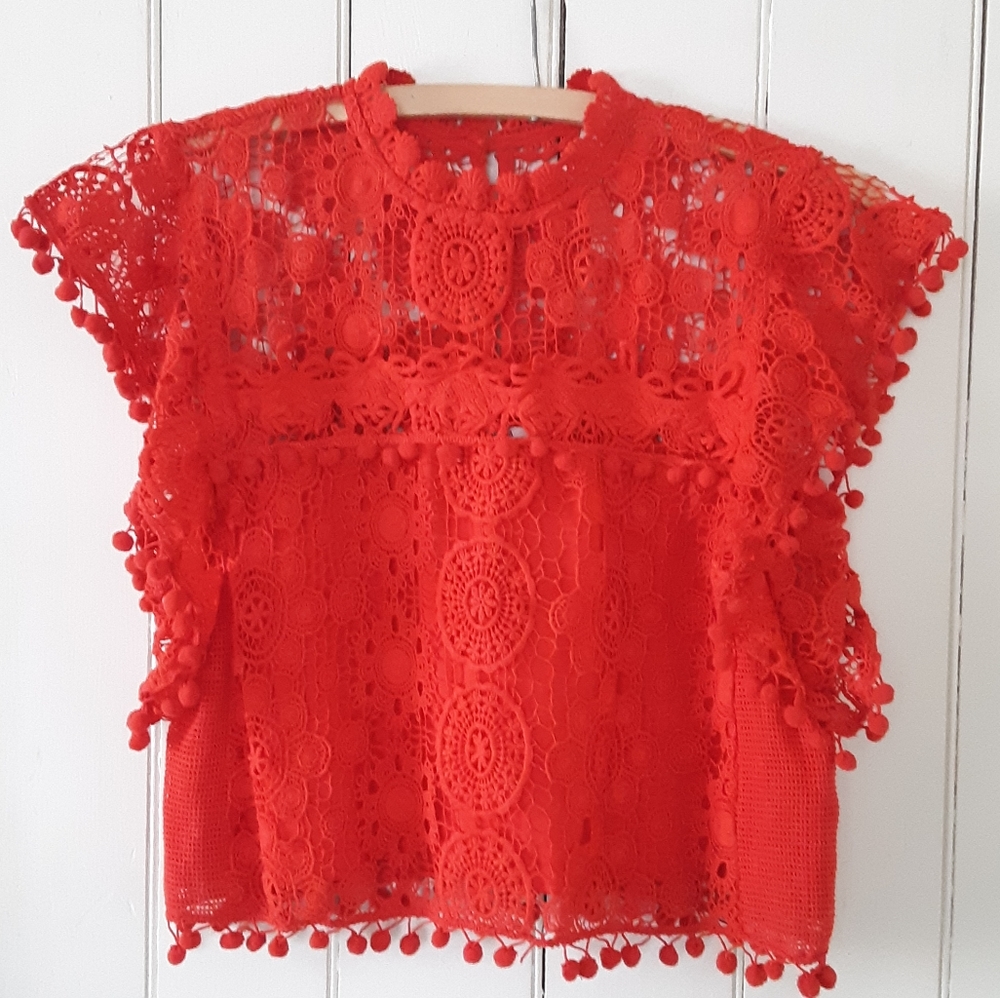 Folk style top with pom poms